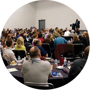 Group of people listening to a speaker at a conference