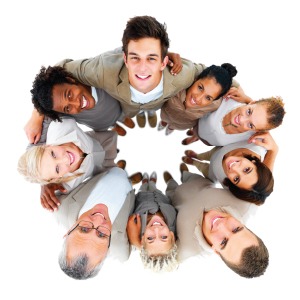 Bird's eye view of a group of people embracing each other in a circle, looking up at the camera.
