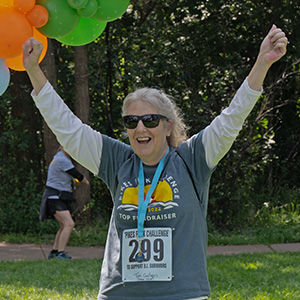 Woman in a wheelchair with a woman standing behind her smiling, at the Manitou Walk